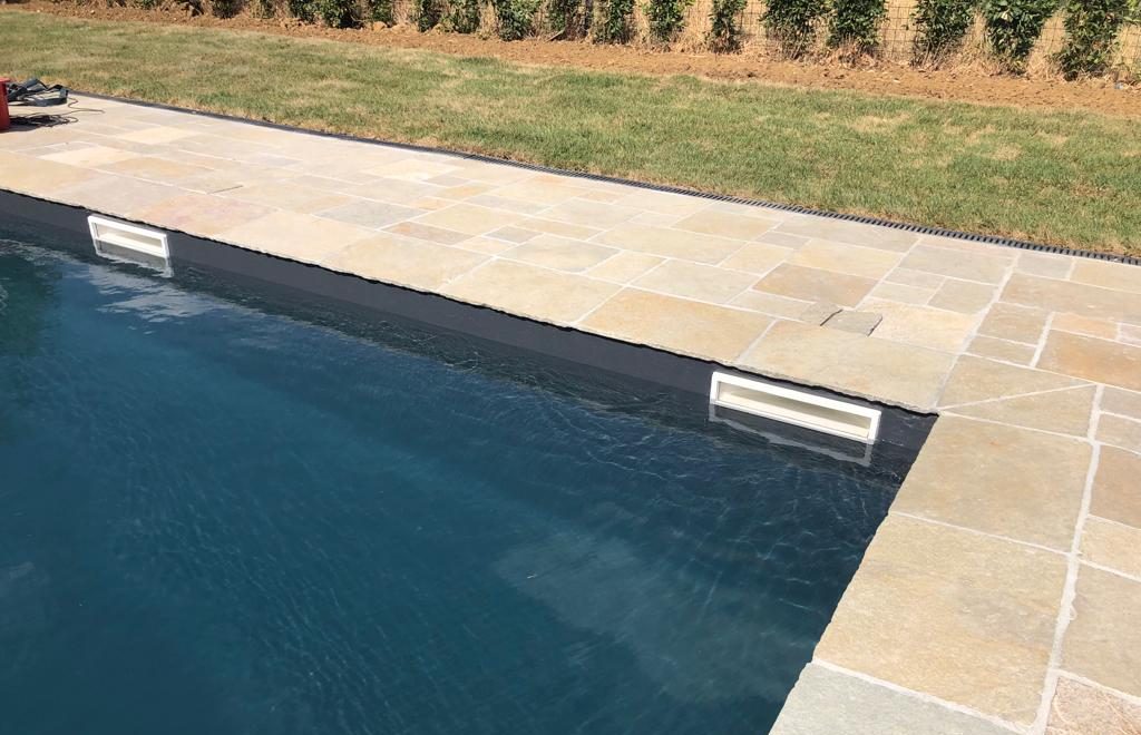 Parete di una piscina con le bocchette degli skimmer